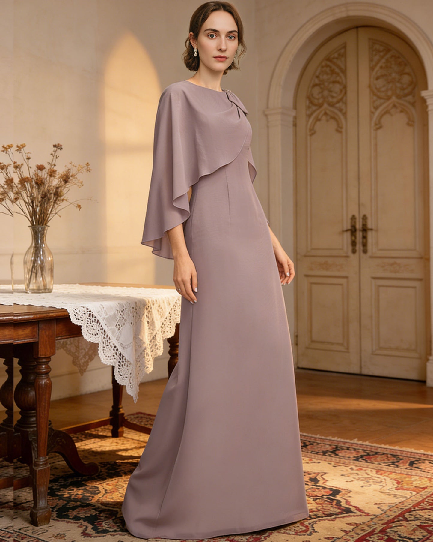 long cape sleeve mother of the bride dress with jewel neckline, bow shoulder, and chiffon column skirt shown in formal wedding guest styling