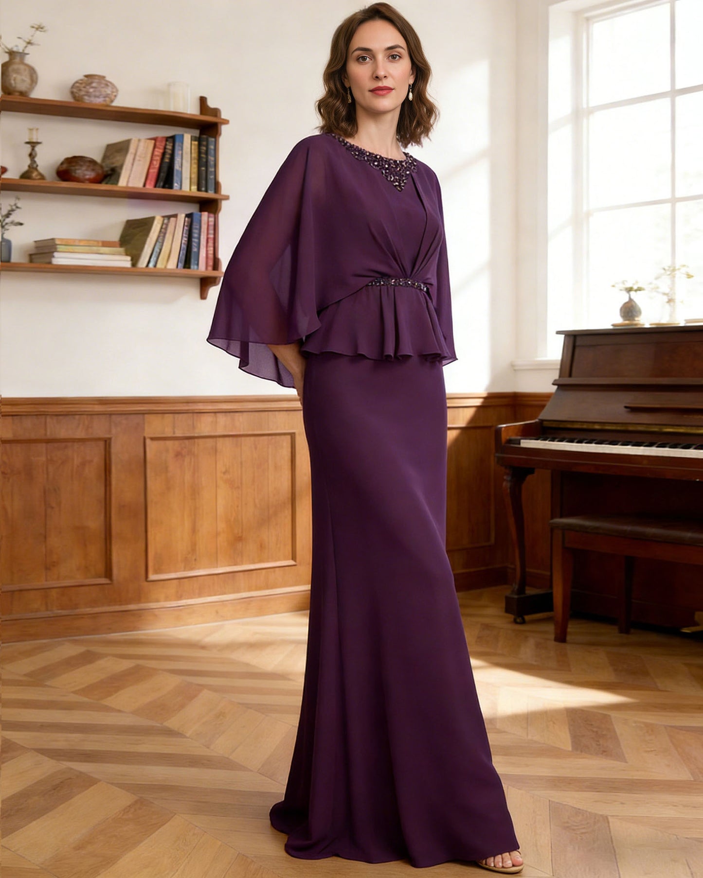 long capelet mother of the bride dress with beaded neckline, peplum overlay, and floor length chiffon skirt alternate angle showing the formal dress silhouette and drape