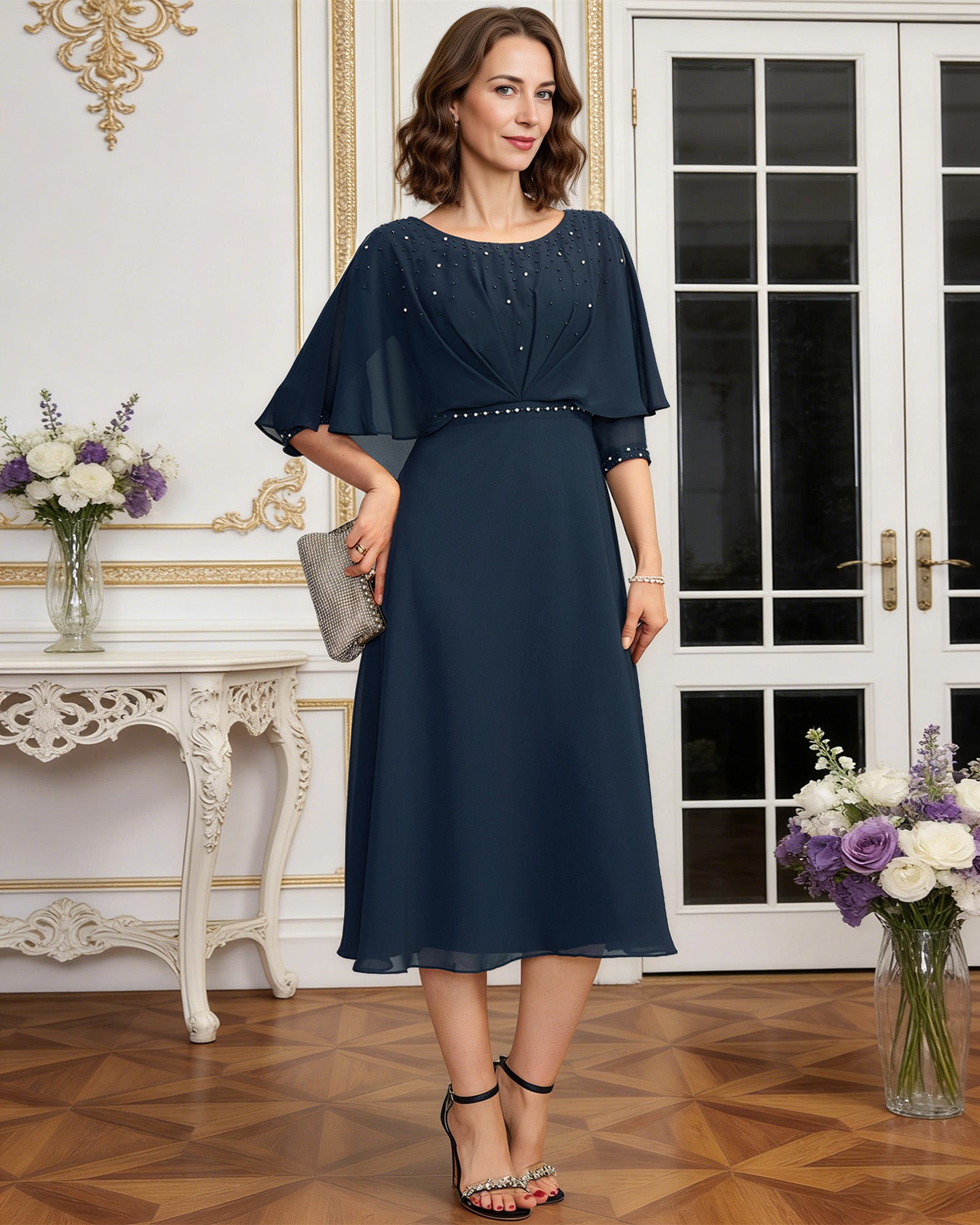 tea length chiffon mother of the bride dress with beaded cape overlay and A-line skirt back or side view for mother of the bride occasion styling