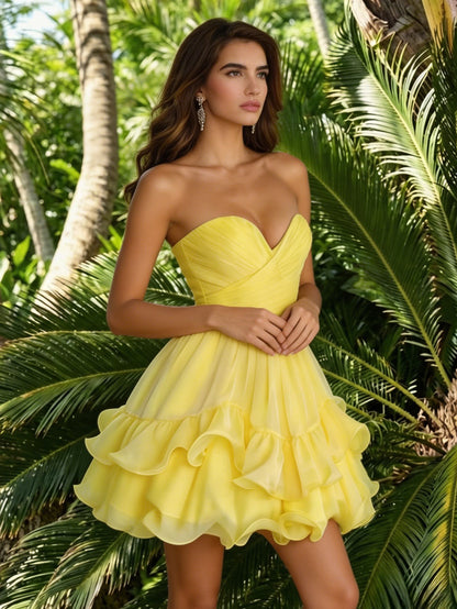 baby pink strapless chiffon homecoming dress with layered ruffle skirt.
