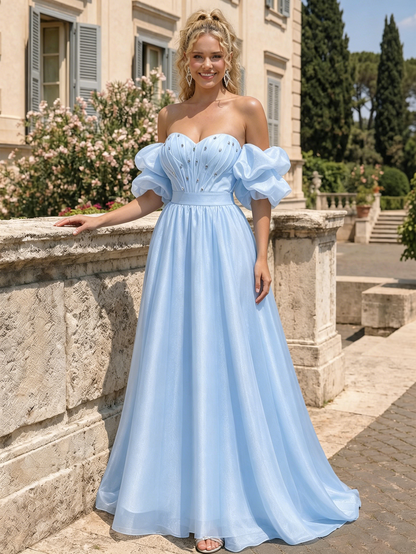 formal dress look featuring a spaghetti strap beaded corset bodice, ruched satin skirt, floor-length silhouette, and high front slit.